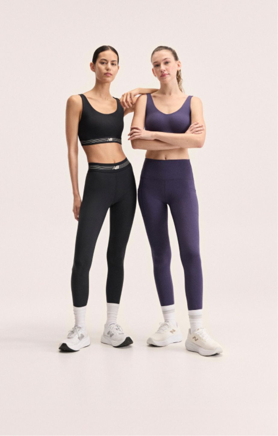 Two women standing wearing new balance leggings
